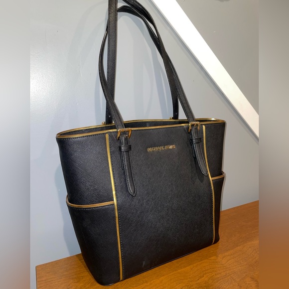 Michael Kors Handbags - Michael Kors black and gold trimmed tote/ shoulder bag. Slightly used